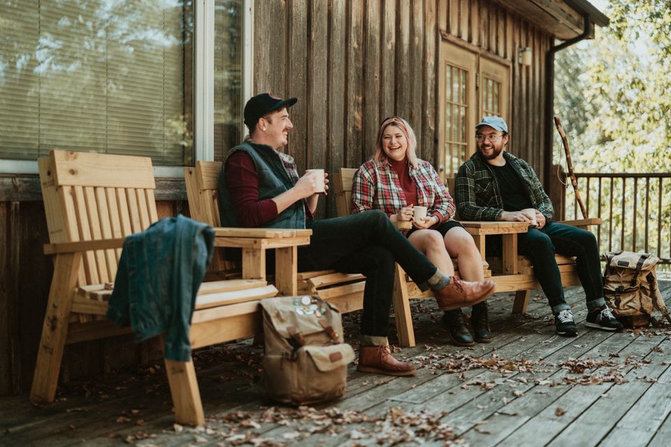 People sitting on a cabin porch