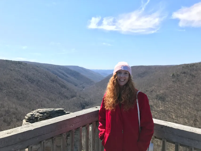 Author, Amanda Larch standing at an outlook in the mountains of WV